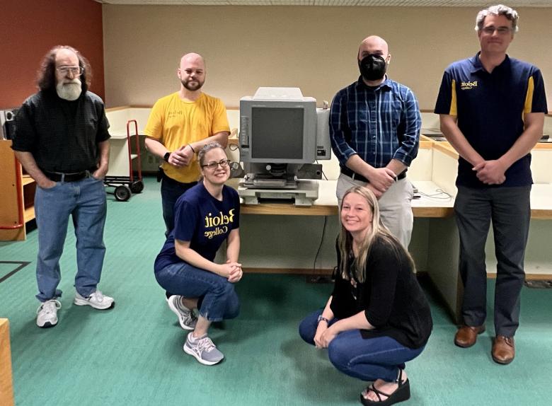 Photo caption: Beloit College Library staff hand the microfilm reader to Beloit Historical Society Assistant Director Jesse Herscher. (Le...