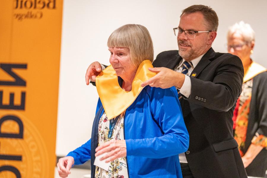 A member of the 50th Reunion Class of 1973 receiving their Golden Stole from President Boynton.